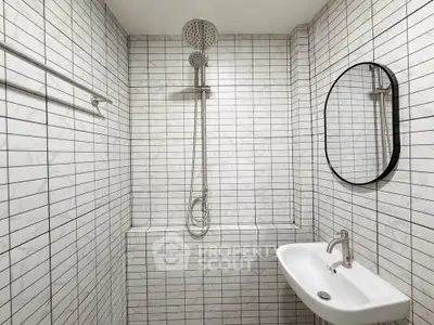 Modern minimalist bathroom with sleek shower and oval mirror