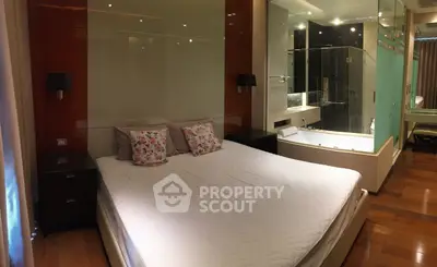 Luxurious bedroom with modern design and ensuite bathroom featuring a bathtub, perfect for relaxation.