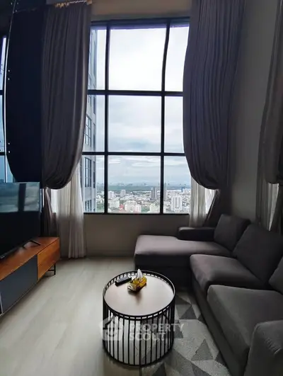 Stunning high-rise living room with panoramic city view and modern furnishings.