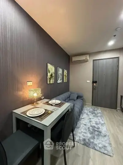 Modern living room with stylish decor and cozy dining area in a contemporary apartment.