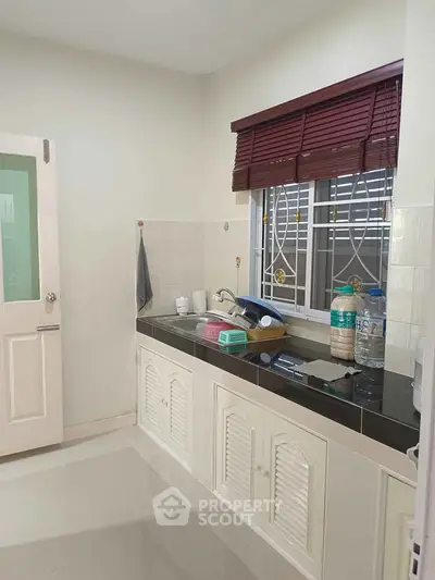 Charming kitchen with sleek countertops and ample natural light