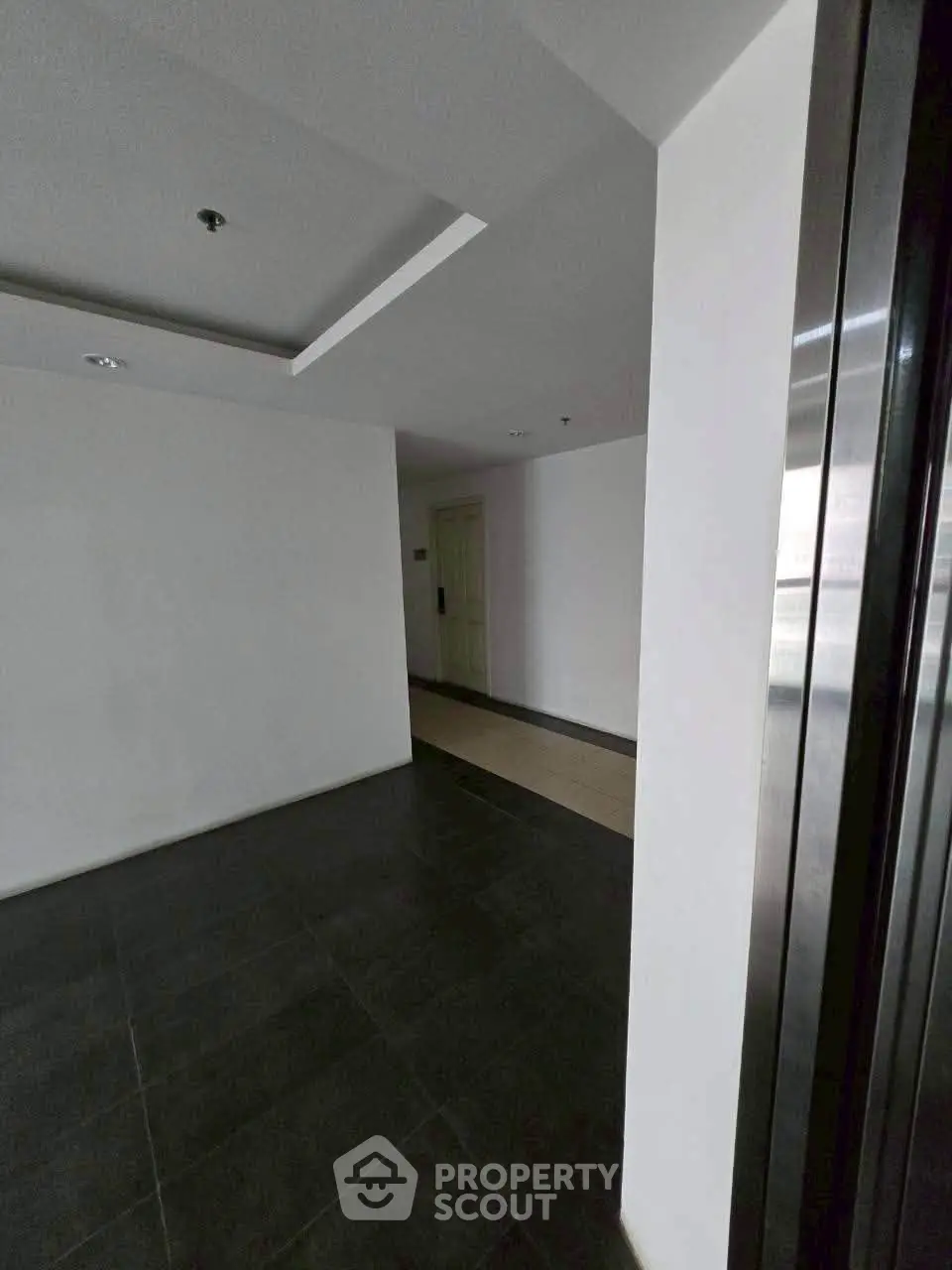 Modern building corridor with sleek elevator and minimalist design