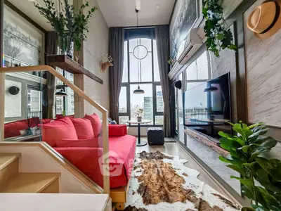 Stylish modern living room with high ceilings and city view