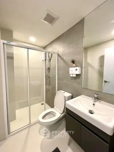 Modern bathroom with glass shower and sleek fixtures
