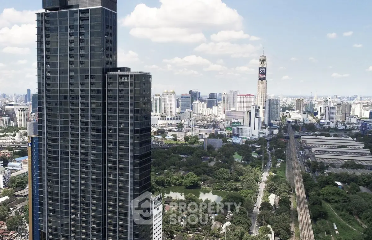 Stunning cityscape view with modern high-rise building and lush greenery.