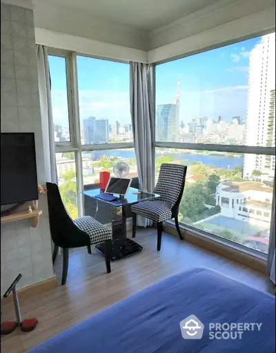 Stunning city view from modern bedroom with floor-to-ceiling windows and elegant decor.