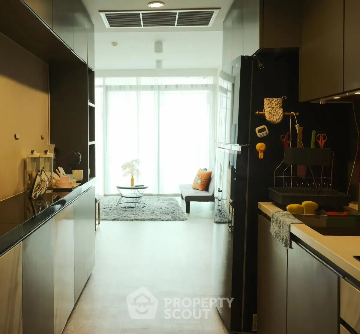 Modern kitchen with sleek black cabinets and bright natural light