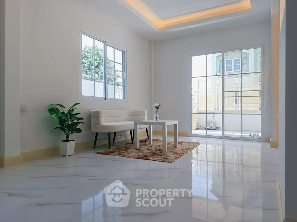 Spacious modern living room with large windows and elegant decor