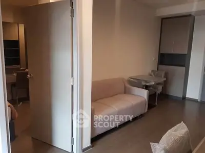 Cozy living room with modern sofa and dining area in a stylish apartment.