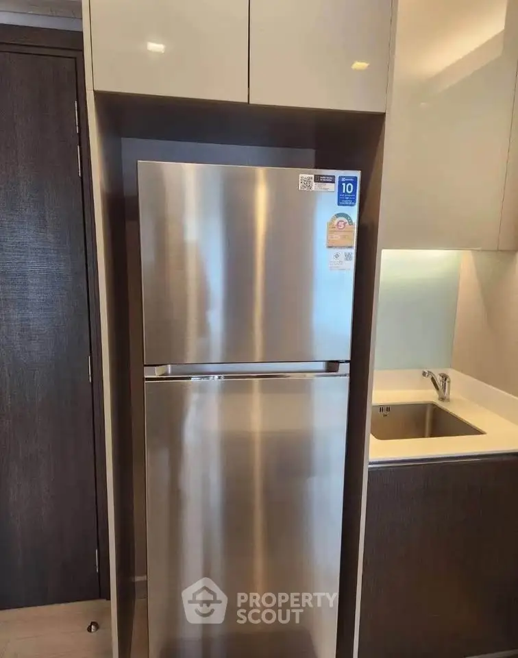 Modern kitchen with stainless steel fridge and sleek cabinetry