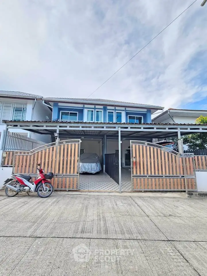 Charming two-story house with modern facade and spacious driveway in a serene neighborhood.