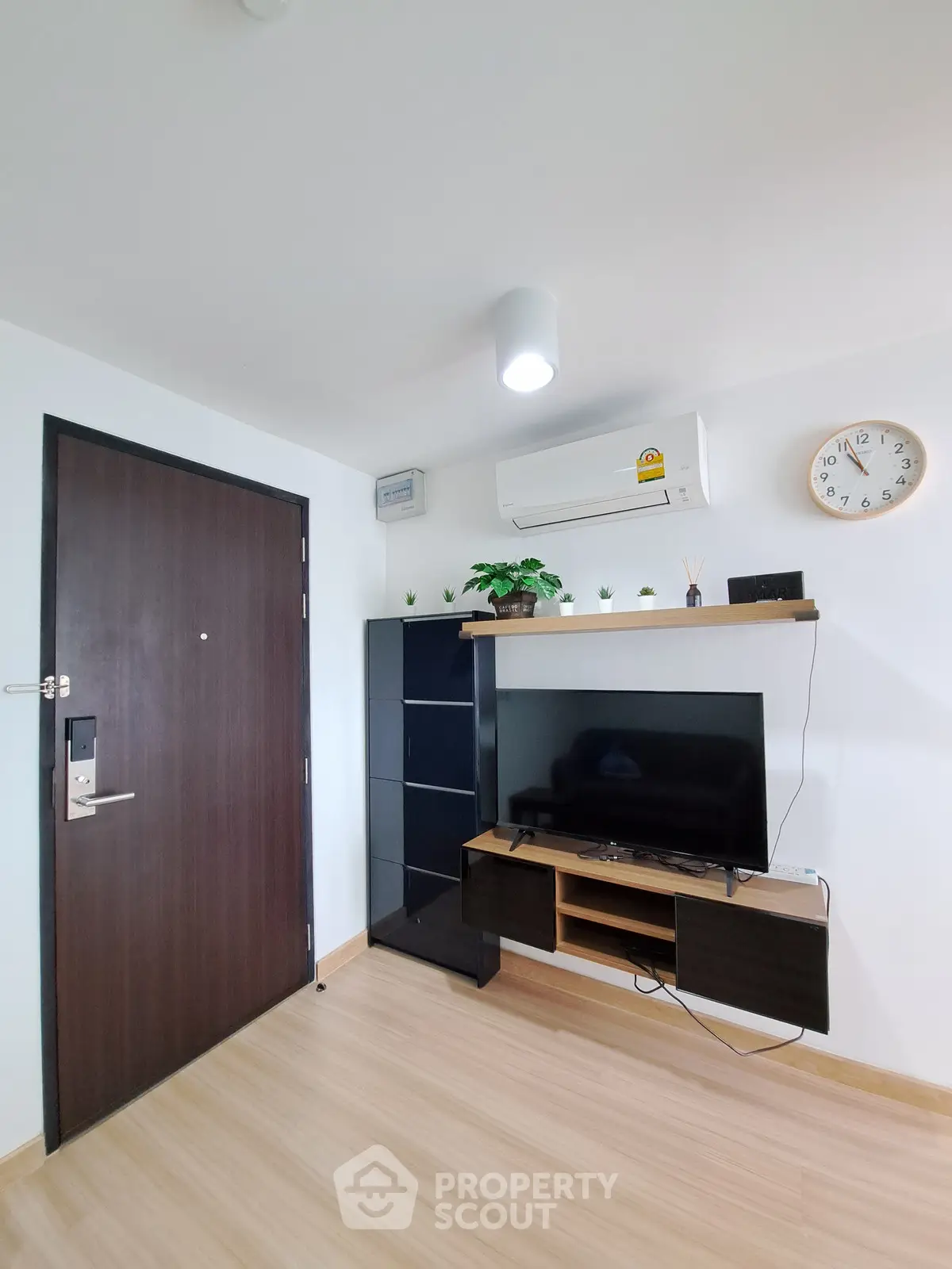 Modern living room with sleek TV setup and stylish storage solutions.