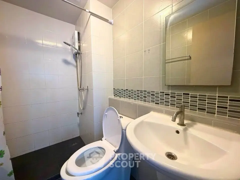 Modern bathroom with sleek fixtures and a spacious shower area.