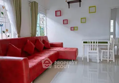 Charming living room with vibrant red sofa and modern decor accents