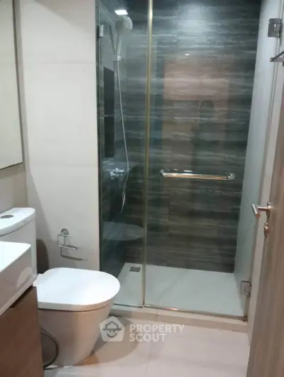 Modern bathroom with glass shower enclosure and sleek fixtures