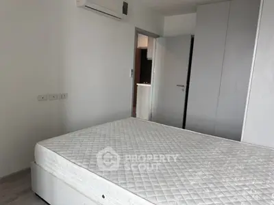 Spacious bedroom with modern air conditioning and ample closet space