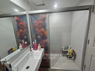 Modern bathroom with glass shower enclosure and sleek sink design