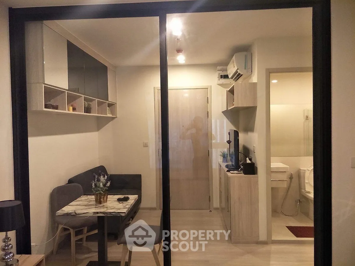 Modern compact living room with dining area and glass partition