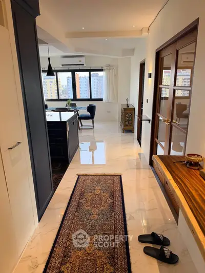 Spacious open-plan living area with modern kitchen and elegant decor