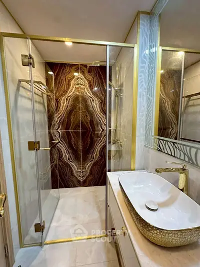 Luxurious bathroom with elegant marble shower and stylish gold fixtures