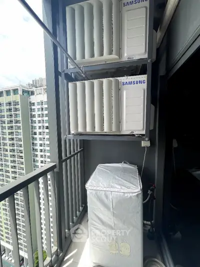 Modern high-rise balcony with air conditioning units and city view