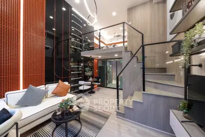 Modern duplex living room with stylish decor and mezzanine level, featuring sleek design and ample natural light.