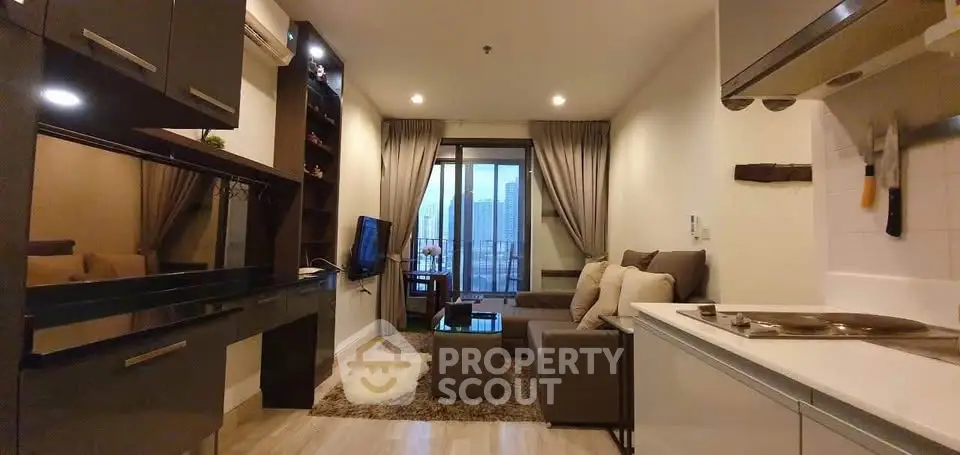 Modern living room with open kitchen and city view balcony in stylish apartment.