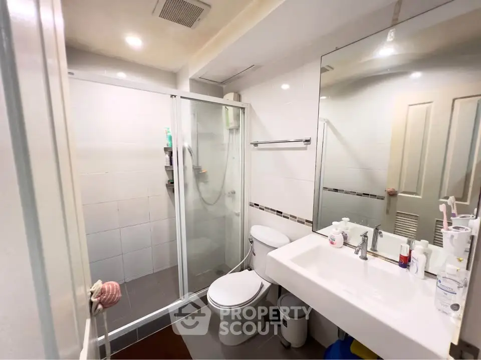 Modern bathroom with glass shower and sleek fixtures in a bright, clean design.