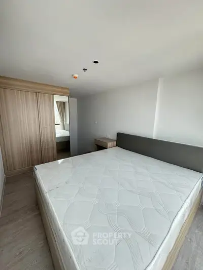 Spacious bedroom with modern design and large wardrobe
