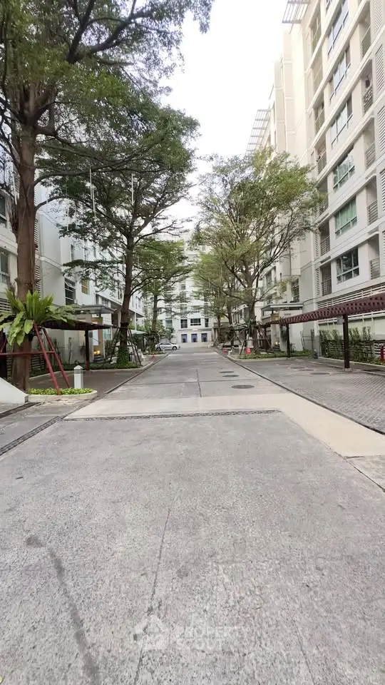 Modern residential building with lush greenery and spacious driveway