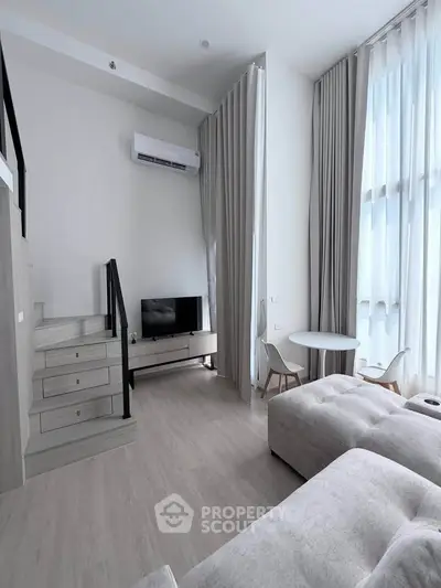 Modern loft-style living room with high ceilings and elegant decor