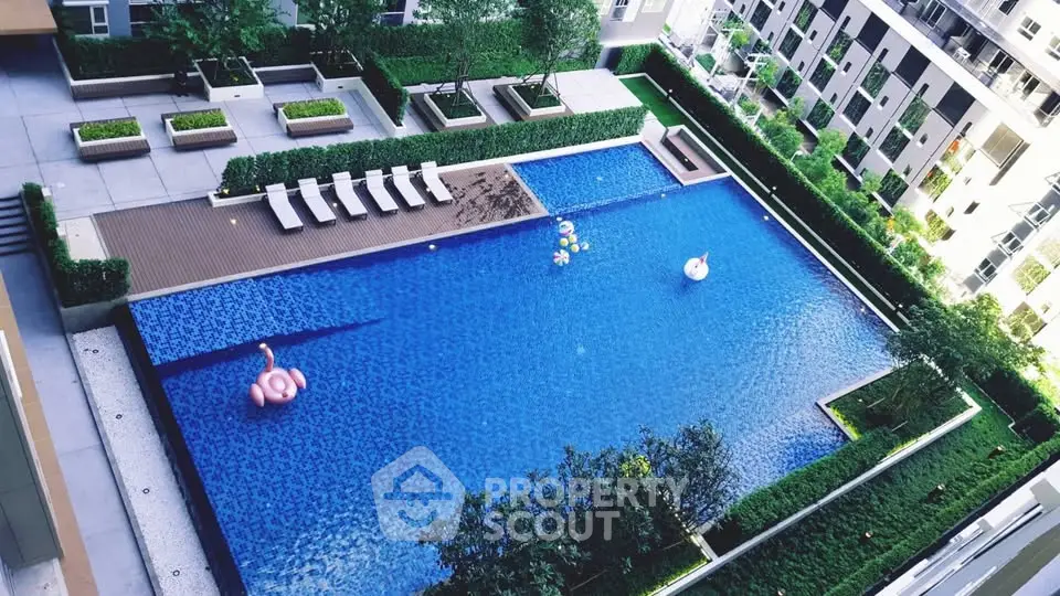 Luxurious residential complex with a stunning outdoor pool and lush greenery.