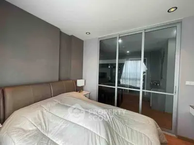 Modern bedroom with sleek design and large mirrored closet doors