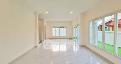 Spacious bright living room with large windows and marble flooring