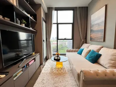 Cozy living room with modern decor and city view, featuring plush sofa and large TV.