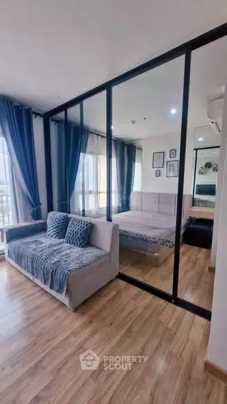 Modern apartment with glass partition, cozy living area, and stylish bedroom.