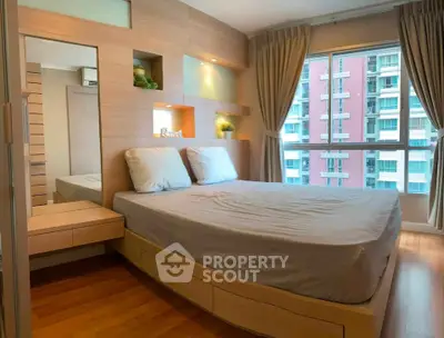 Modern bedroom with large window and built-in storage in urban apartment