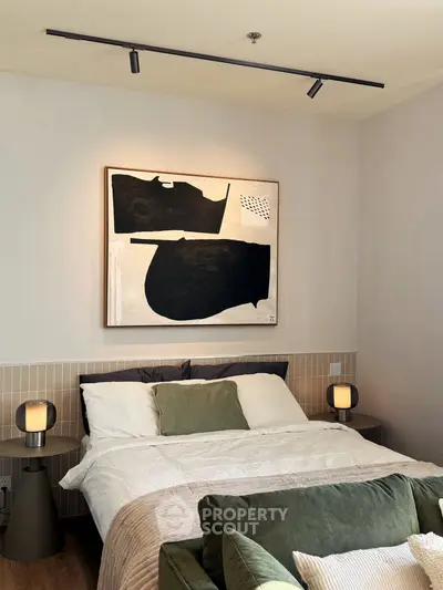 Modern bedroom with stylish abstract art and cozy lighting