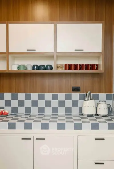 Modern kitchen with stylish checkered backsplash and sleek cabinetry