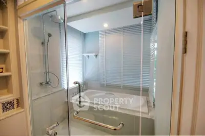 Luxurious bathroom with glass shower and bathtub in modern home
