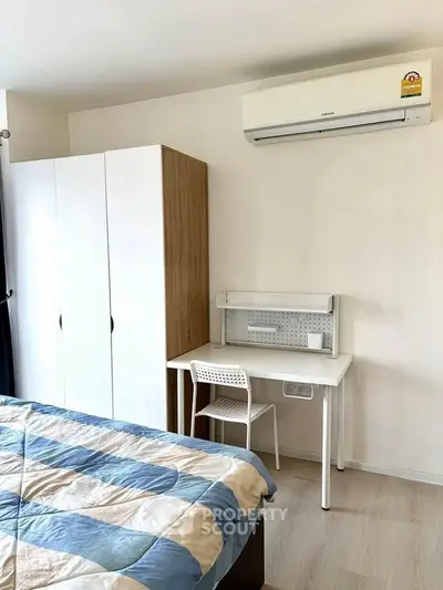 Modern bedroom with air conditioning and stylish furniture