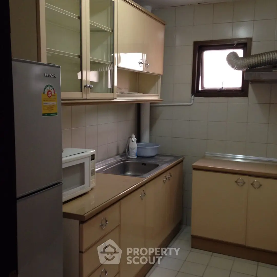 Cozy kitchen with closed layout featuring modern appliances and ample storage space.