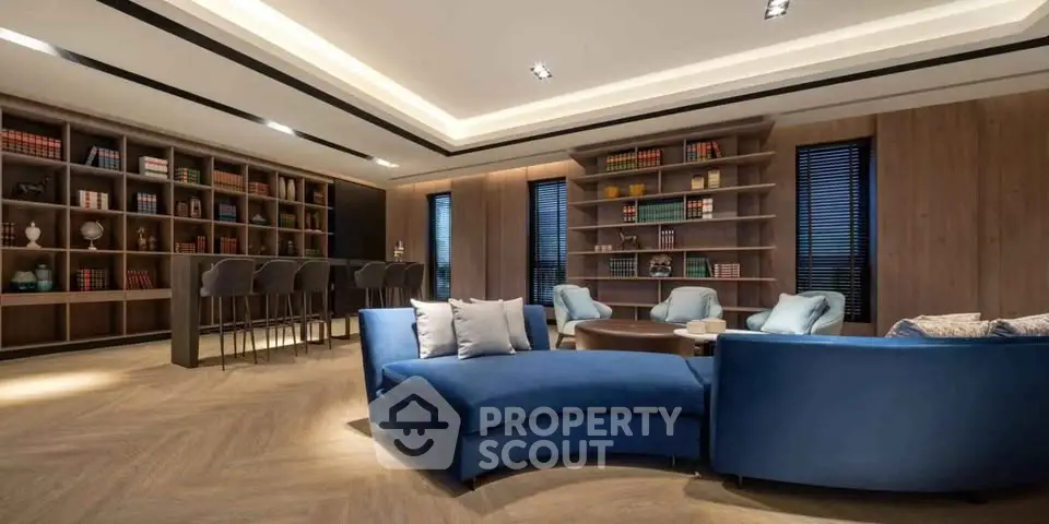 Luxurious modern living room with elegant blue sofas and stylish wooden bookshelves.