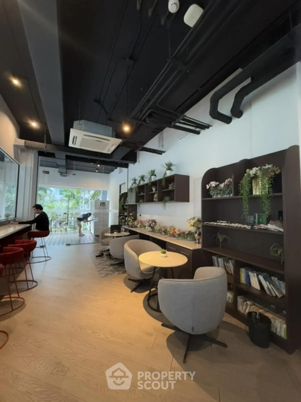 Stylish modern living room with open layout and garden view, featuring elegant furniture and decor.
