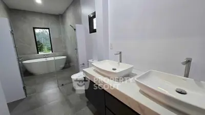 Luxurious modern bathroom with dual sinks and freestanding bathtub
