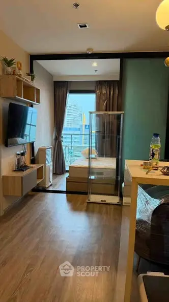 Modern studio apartment with open layout and city view, featuring stylish decor and natural light.