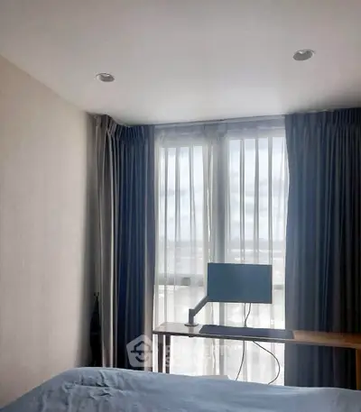 Modern bedroom with large window and minimalist desk setup