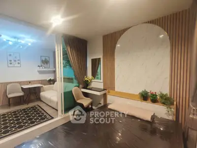 Modern bedroom with stylish decor and adjacent living area in open layout apartment.