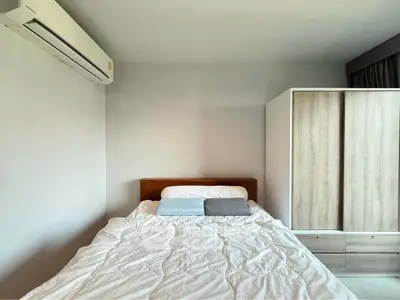 Cozy bedroom with modern air conditioning and spacious wardrobe