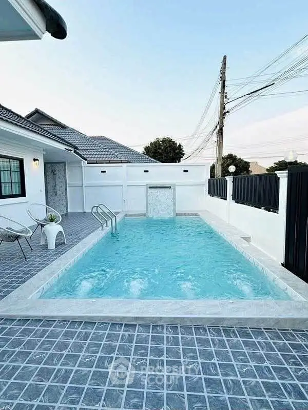 Charming modern home with private pool and stylish outdoor seating area.